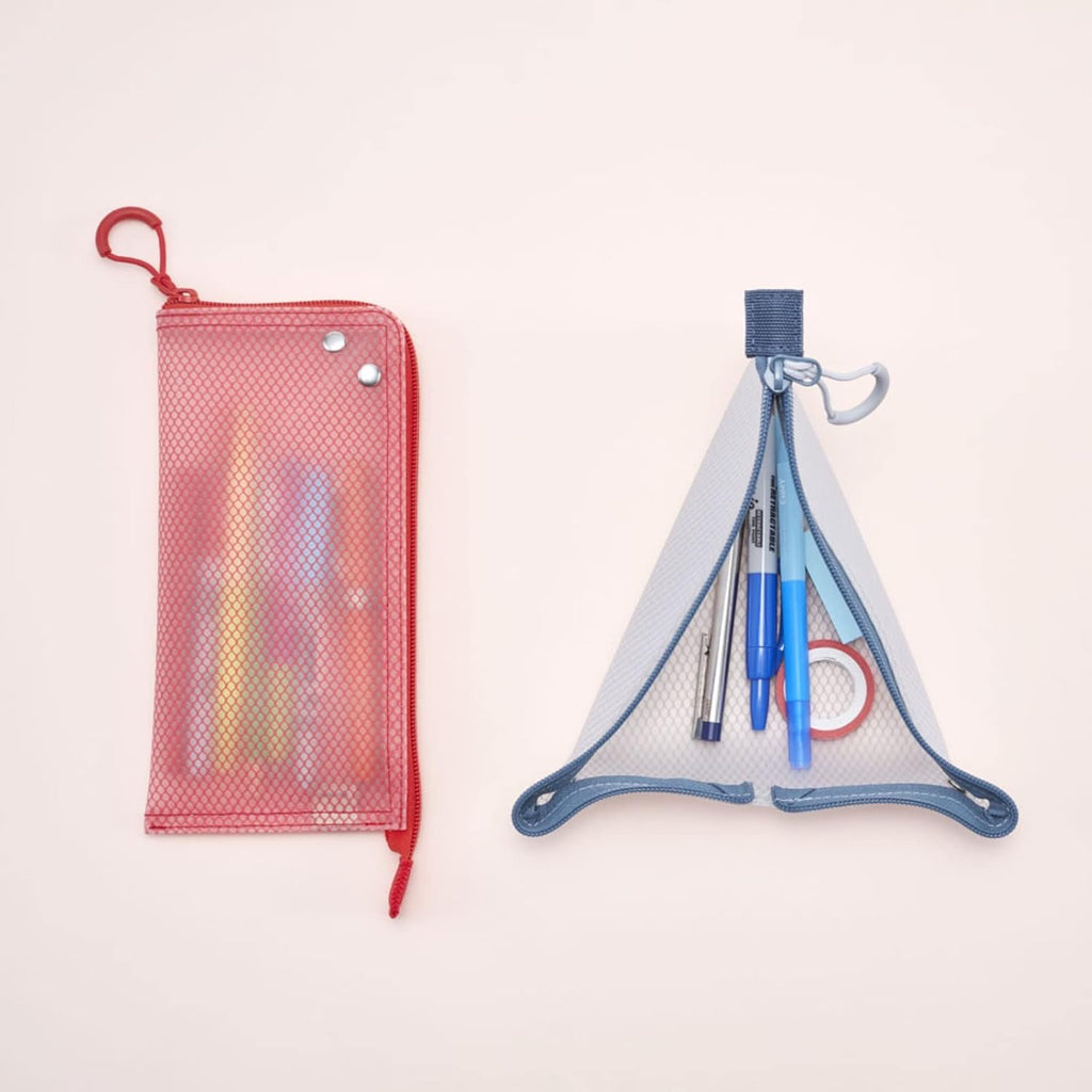 Two mesh pencil pouches shown on a plain light background: a red zip pouch on the left and a blue triangular mesh organizer pouch on the right, both filled with pens and stationery.