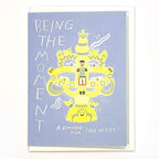 Front image of light blue greeting card with a yellow illustration.