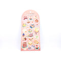 Sheet of cake-themed stickers on a pink back card, placed on white background.