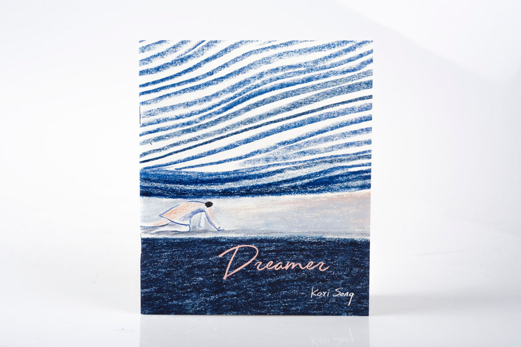 Book with blue and white design and 'Dreamer' text on a white background
