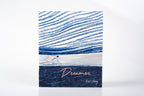Book with blue and white design and 'Dreamer' text on a white background