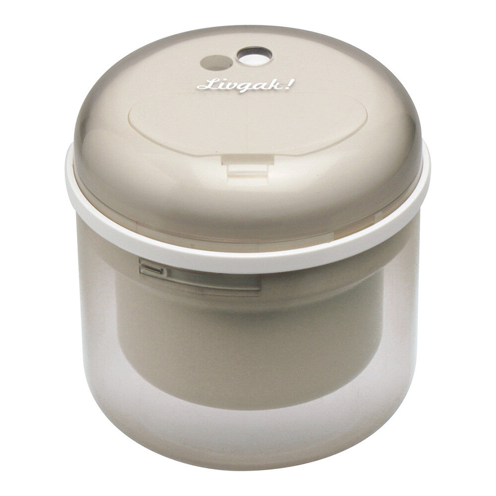 Cylindric electric pencil sharpener in beige on white background.