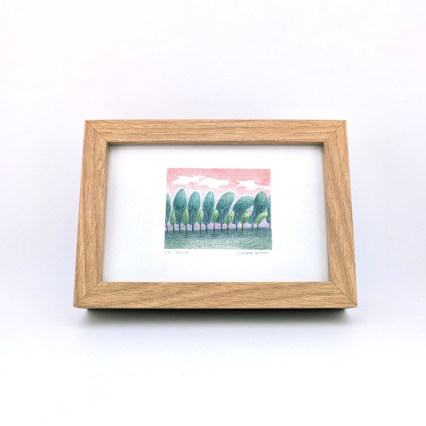 Colour pencil drawing of nature in wooden texture frame on white background.