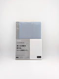 A Japanese memo pad or planner insert in its original packaging, featuring a light blue-gray cover with a white grid section and Japanese text on the front.