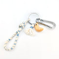 Ceramic croissant keychain handmade by Octoberfourteenth.
