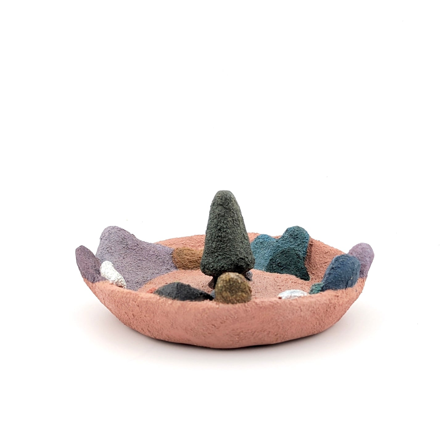 Felted landscape with trees and rocks on a white background