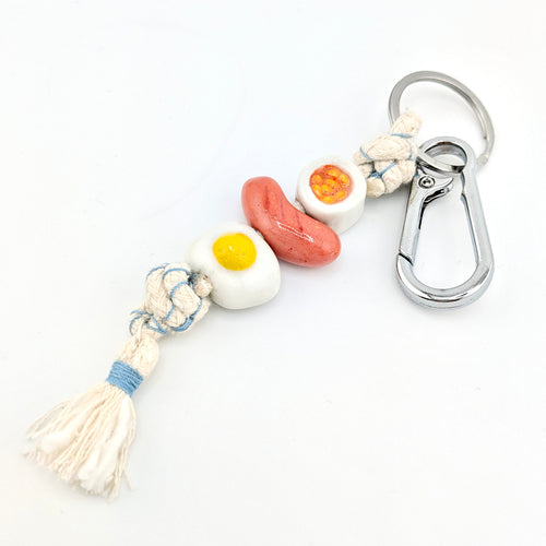 Keychain with english breakfast design on a white background