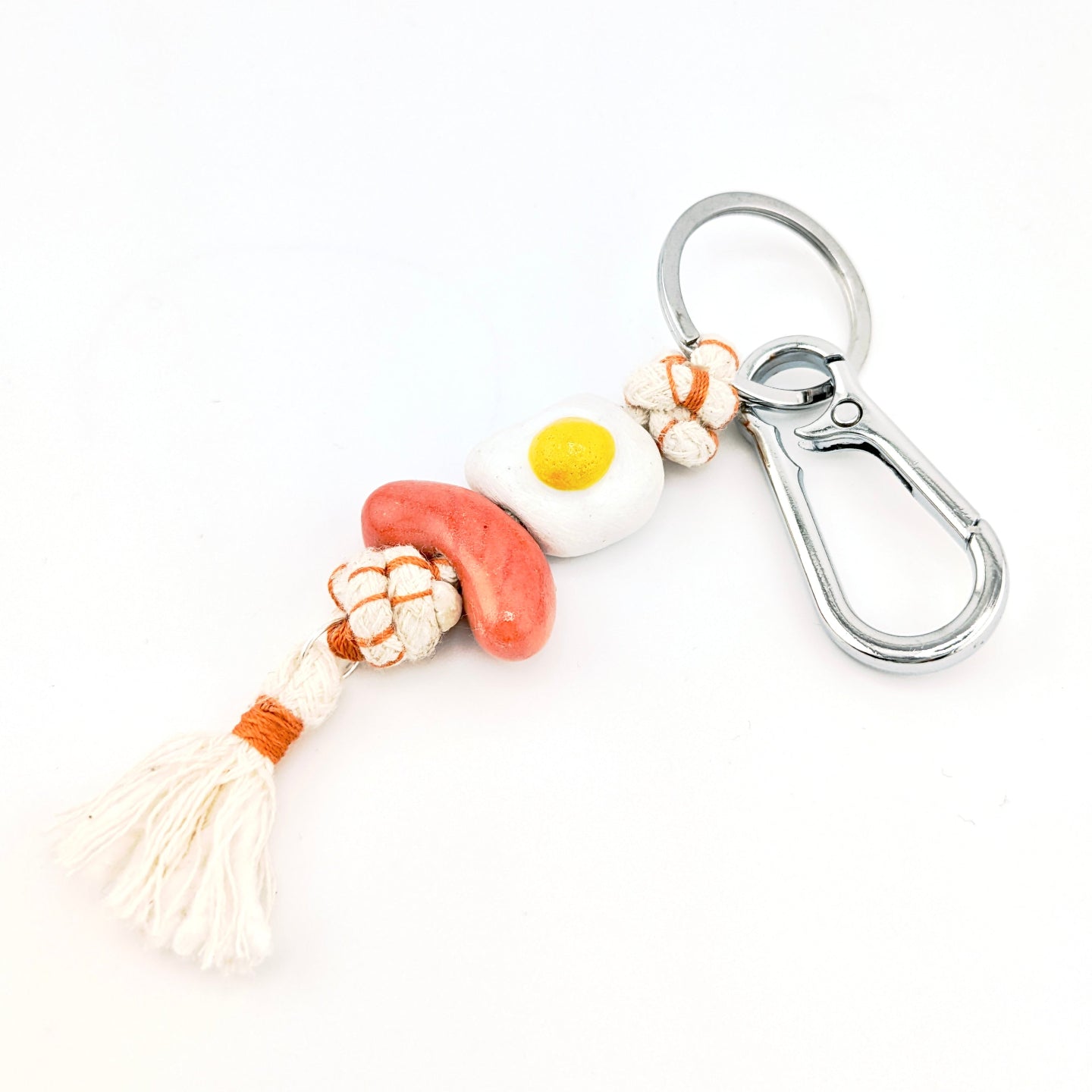 Keychain with tassel and colorful beads on a white background