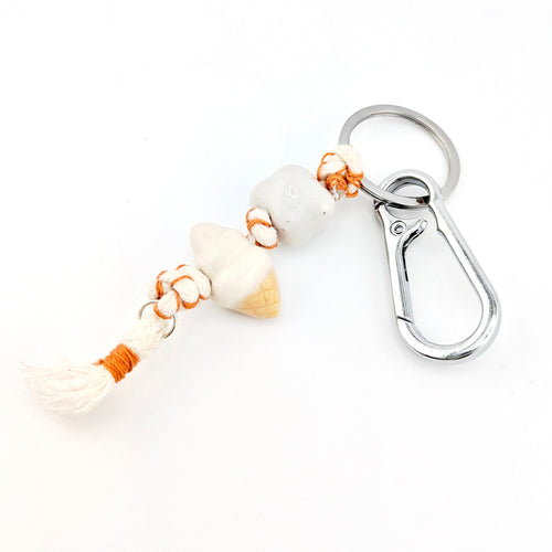 Keychain with shell and rope design on a white background