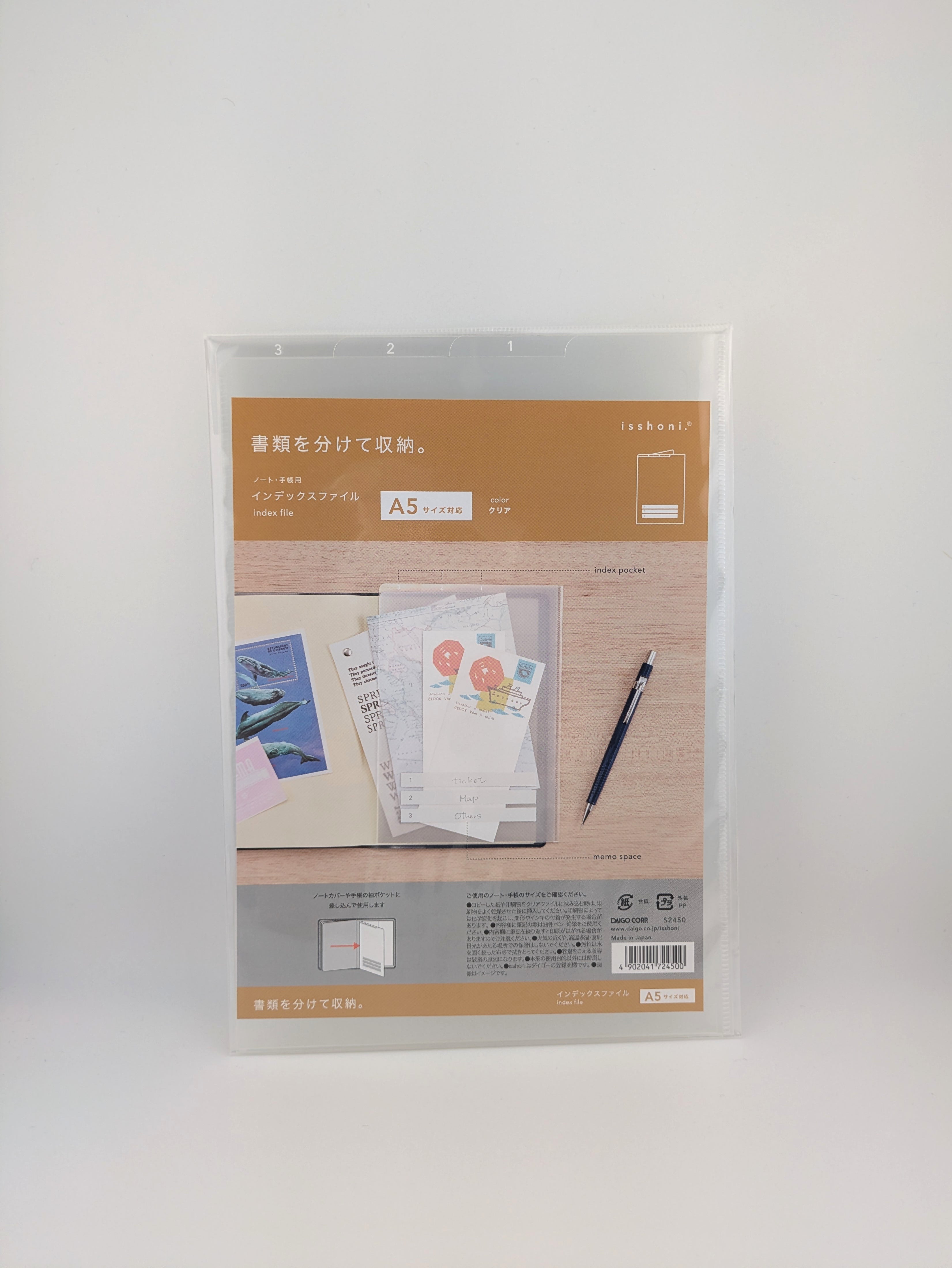 A packaged A5 file organizer with a clear plastic sleeve and a printed insert showing stationery examples, photographed against a plain light gray background.