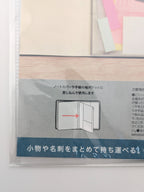 A close-up of a Japanese instruction sheet for a notebook or pocket folder organizer, showing a simple diagram of the product with an arrow indicating how to insert items, alongside Japanese text instructions.