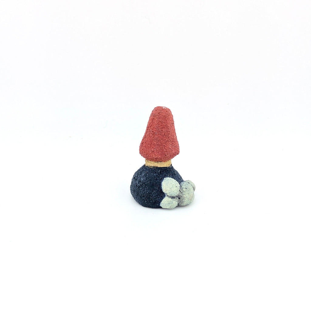 Small red and navy tree-shaped ring holder on white background.