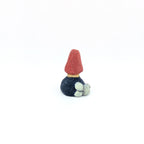 Small red and navy tree-shaped ring holder on white background.