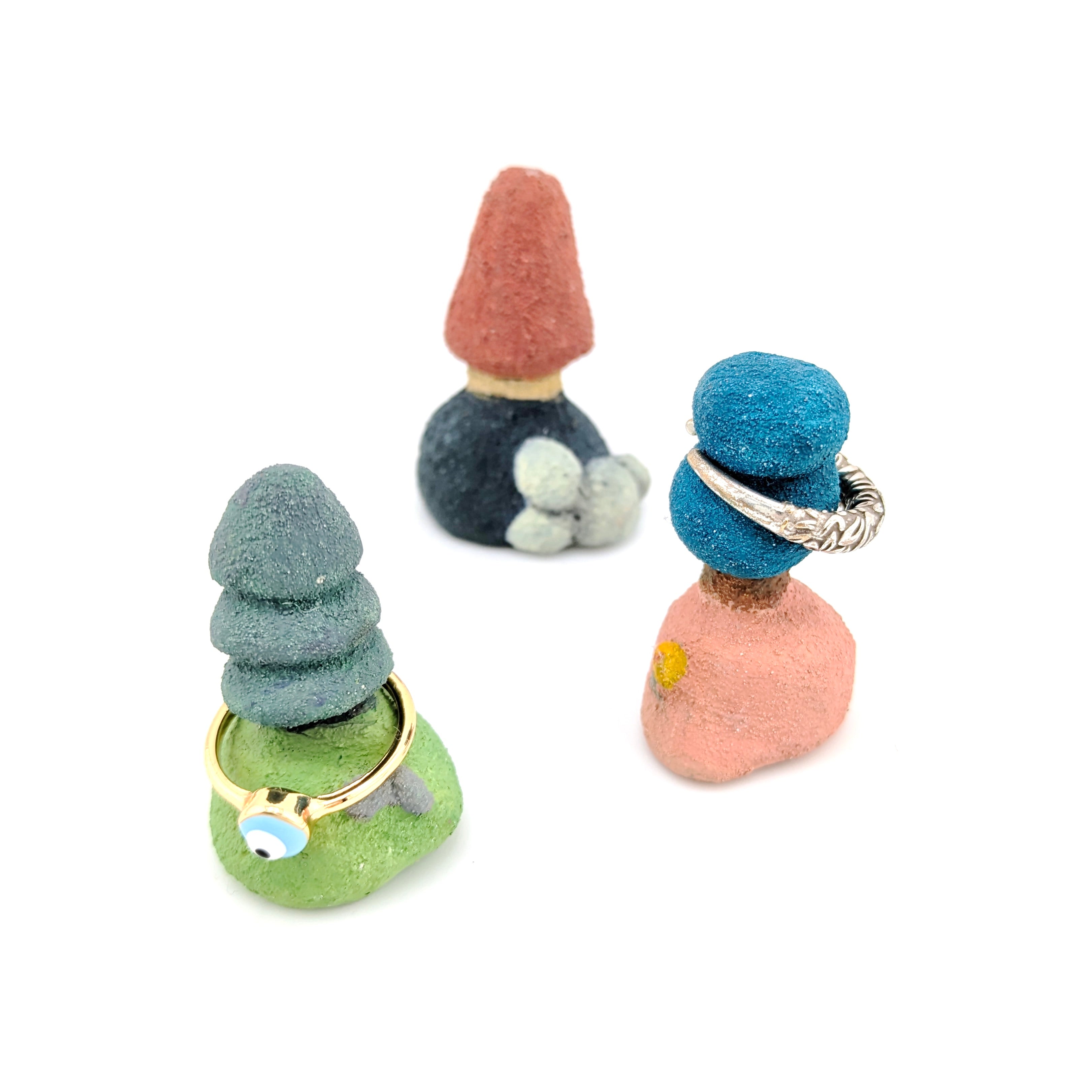 Tree-shaped ring holder in different colours on white background.