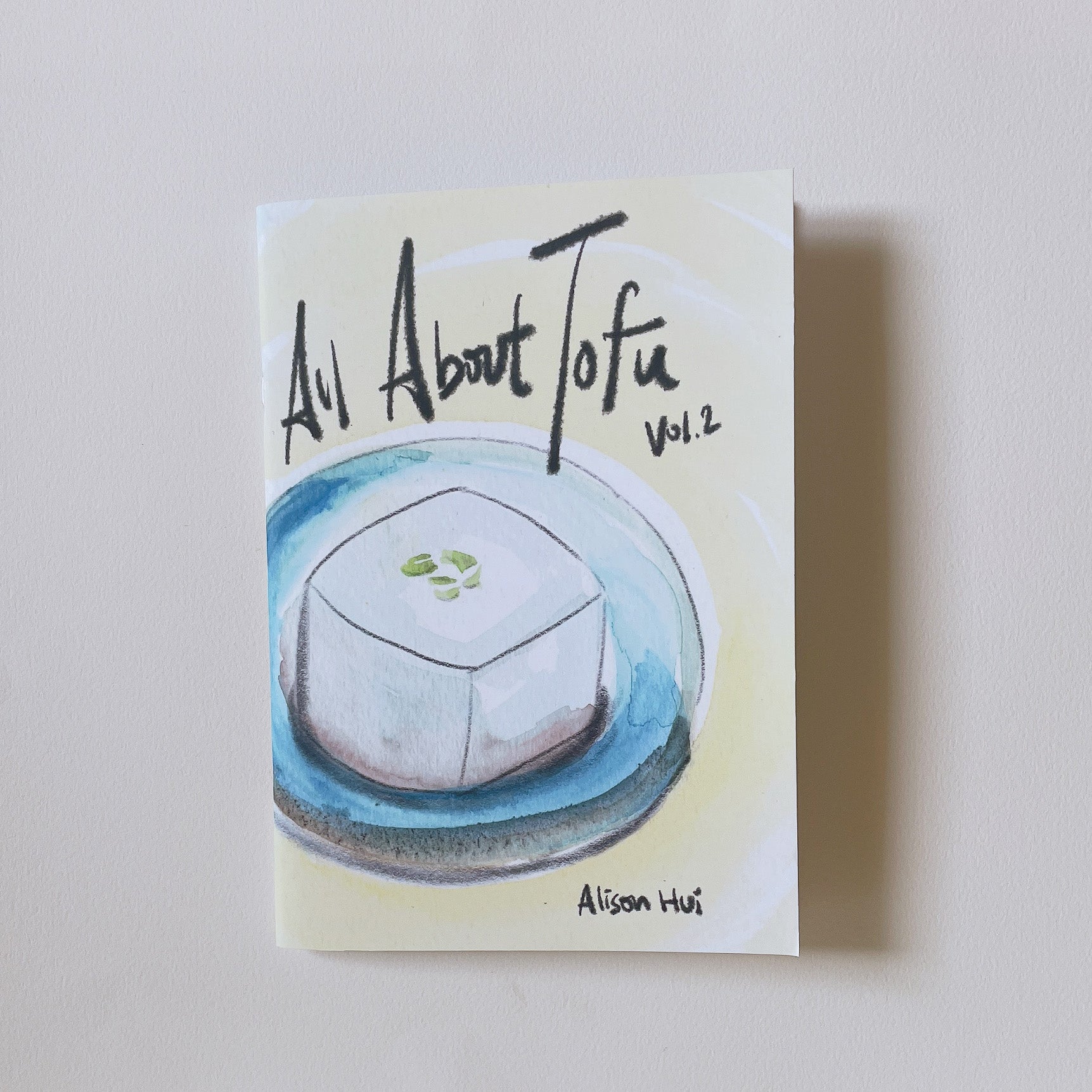 Book titled All About Tofu Vol. 2 with illustration on cover set against white background.