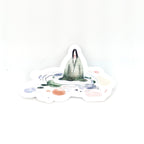 Sticker with a design of a person standing on a mountain peak with colorful circles around them, on a white background.