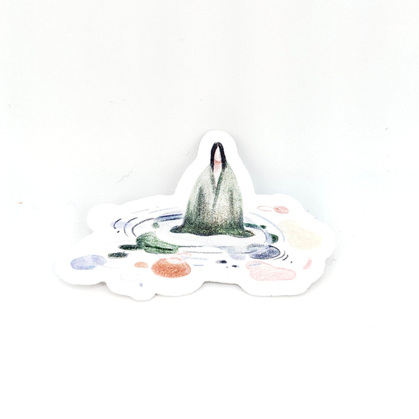 Sticker with a design of a person standing on a mountain peak with colorful circles around them, on a white background.