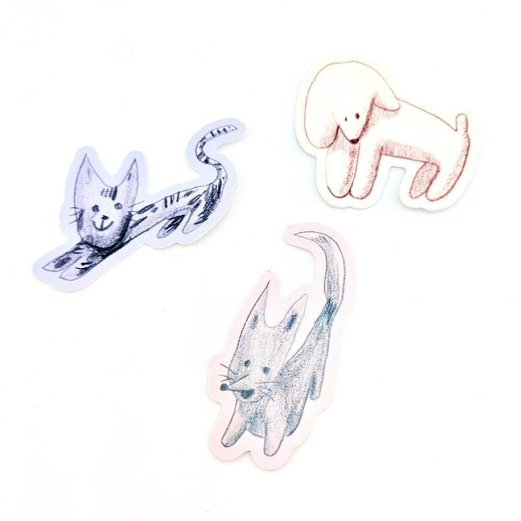 Vinyl stickers of animal illustrations in yellow, pink and purple on white background.